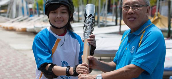 Melissa Leow, on rollerblades, carries the Queen's Baton in Singapore, on Thursday 24 October 2013. Singapore is the seventh country to be visited during the Asian leg of the baton's journey through 70 Commonwealth nations and territories.